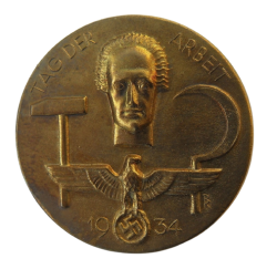 A 1934 National Day of Labour Badge maker marked.