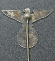 An NSDAP eagle stickpin marked GES.GESCH.