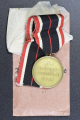 A War Merit Medal In Its Original Paper Packet Of Issue By Gottlieb Keck & Sohn, Pforzheim.