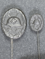 Set Wound Badge Black stickpins, one marked L/18 