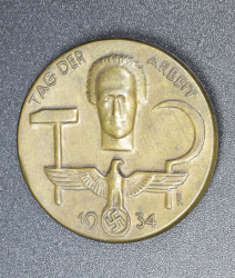 A 1934 National Day of Labour Badge maker marked.