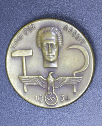 A 1934 National Day of Labour Badge maker marked.